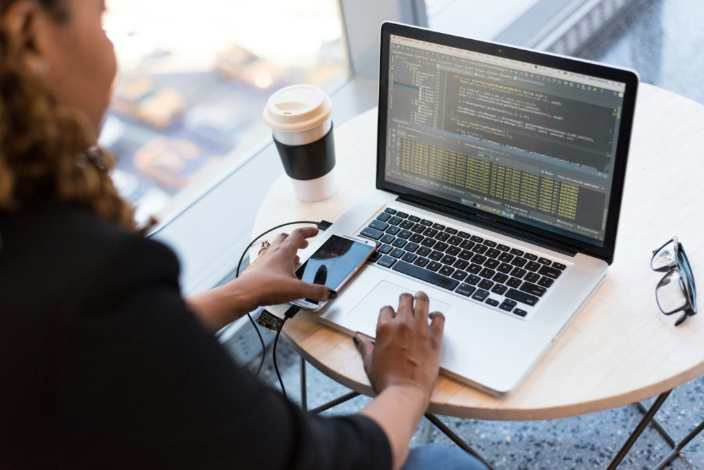 Person coding on a laptop